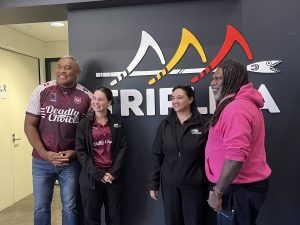 Disability Access Team with Petero standing in front of the Triple A sign.