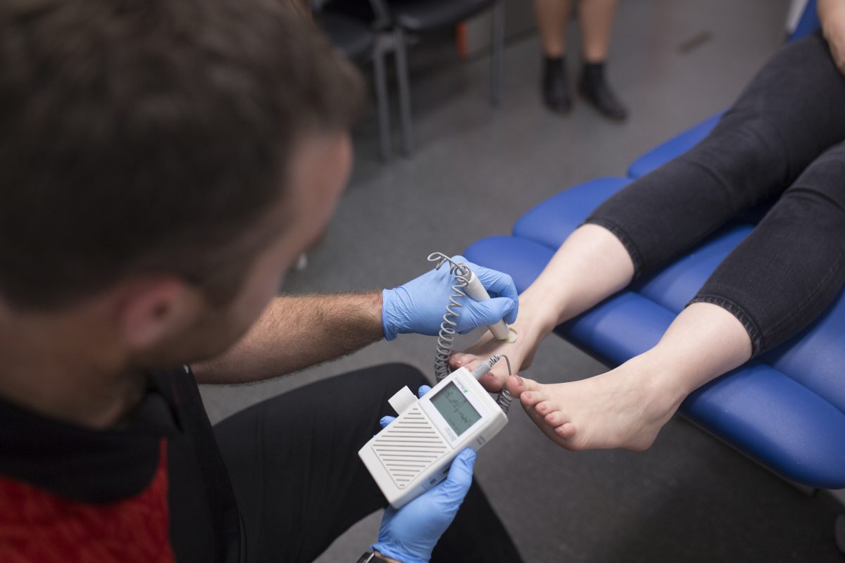 A podiatrist checking someone's foot.